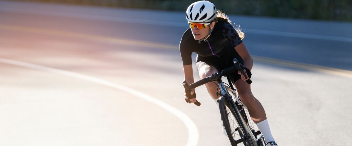 cyclist riding down the road